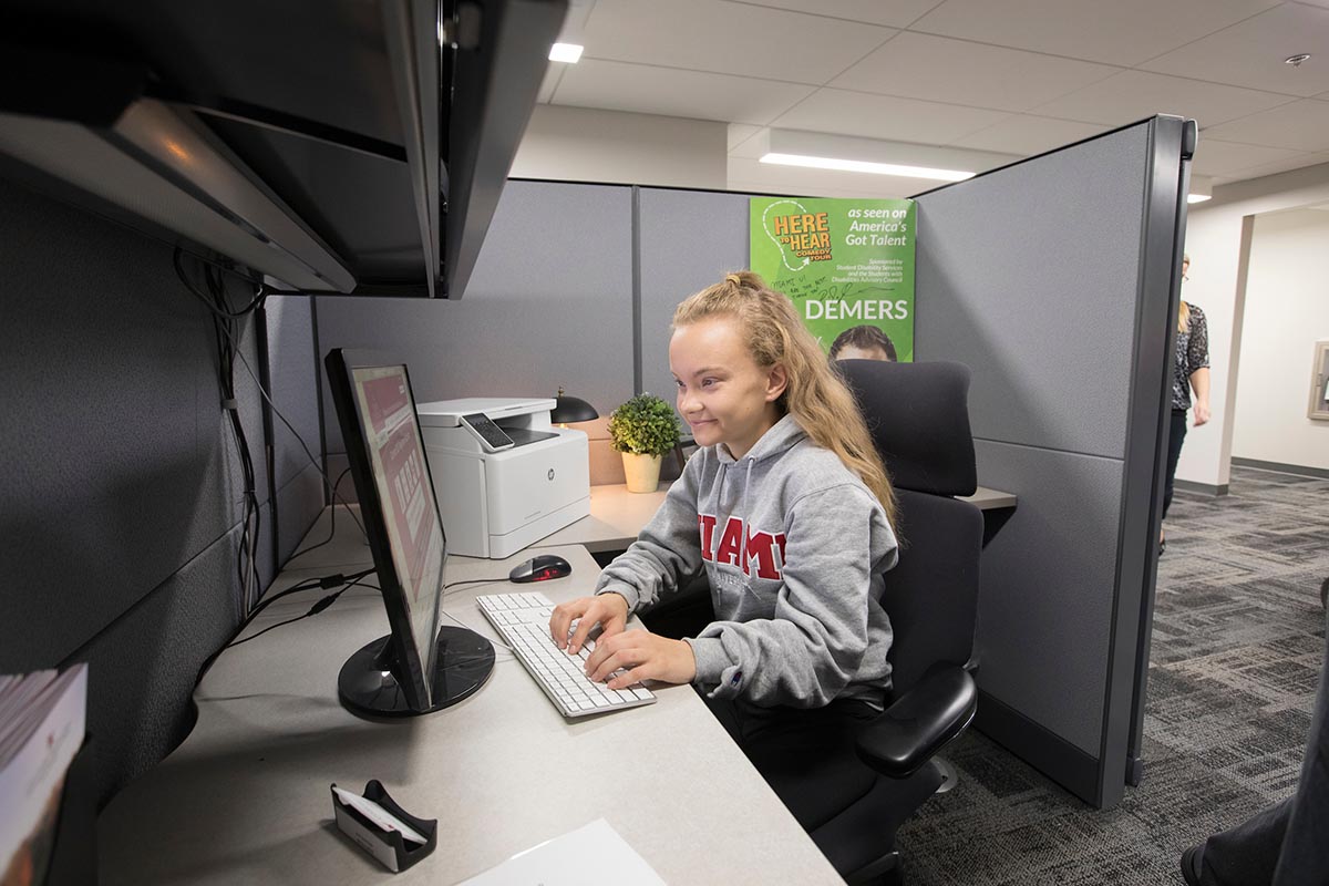 Female student working in a cubicle