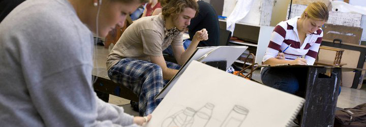 Students working on drawing a still life in charcoal