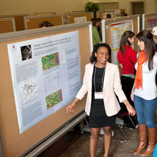 A student giving a Research Forum poster presentation