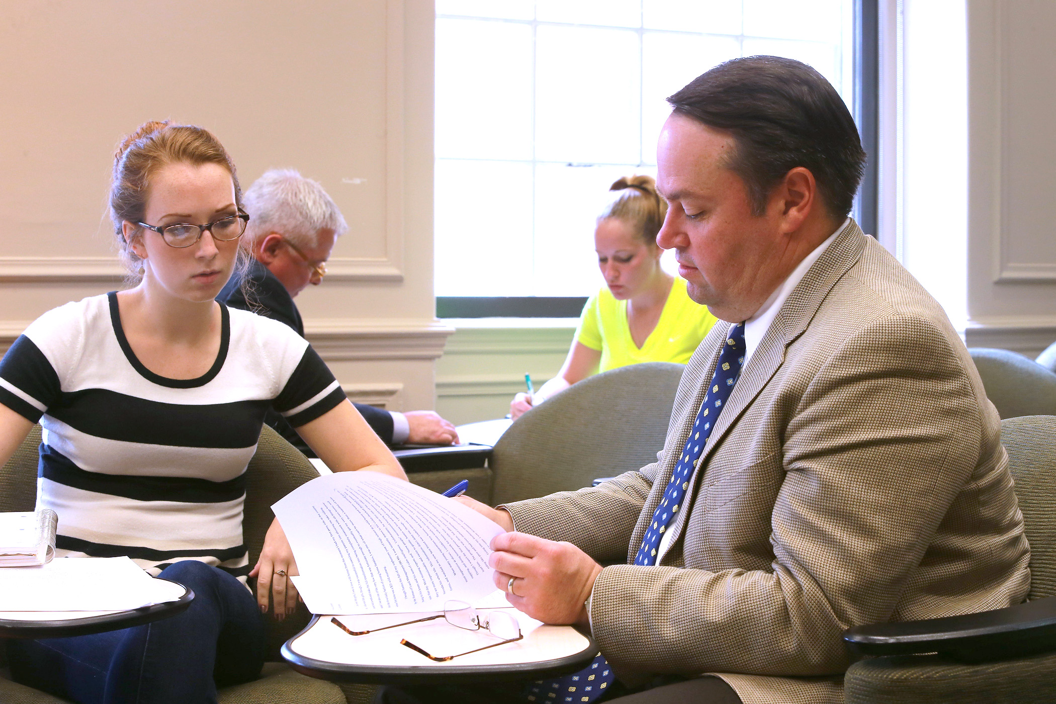 a professor and a student working together on a paper