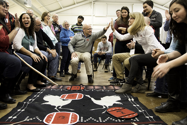 President Crawford and his wife Dr. Crawford participate in moccasin game with MTO members and students