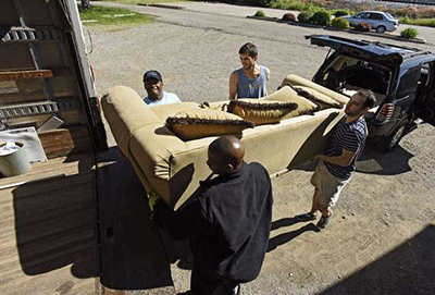 Students load sofa onto truck
