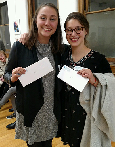 Art student winners hold their prizes. 