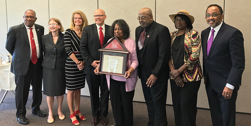 The Williams family receives their father's diploma.