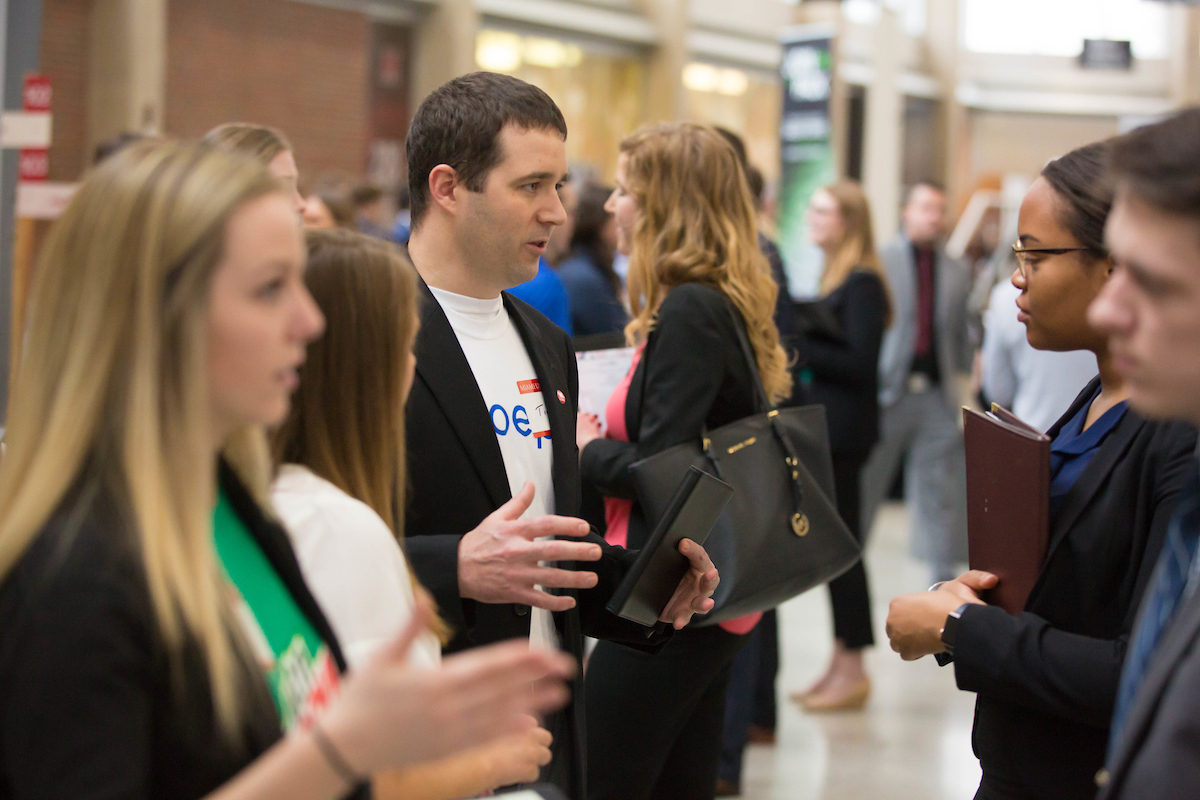 Students chat with employers at the Career Fair