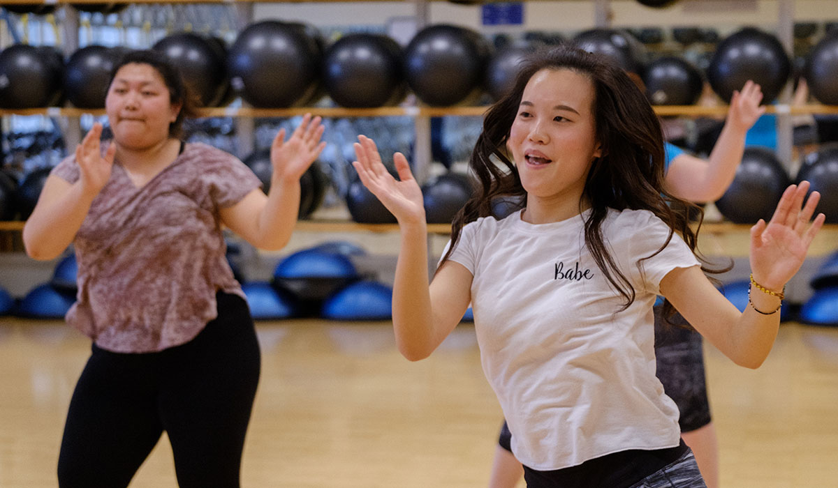 students dancing in a group fitness class