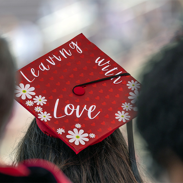 grad cap that says "Leaving with Love"