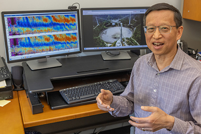 Qihou Zhou in front of his computer showing radar data from the observatory