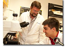 enlarged photo of professor and student scholar in lab
