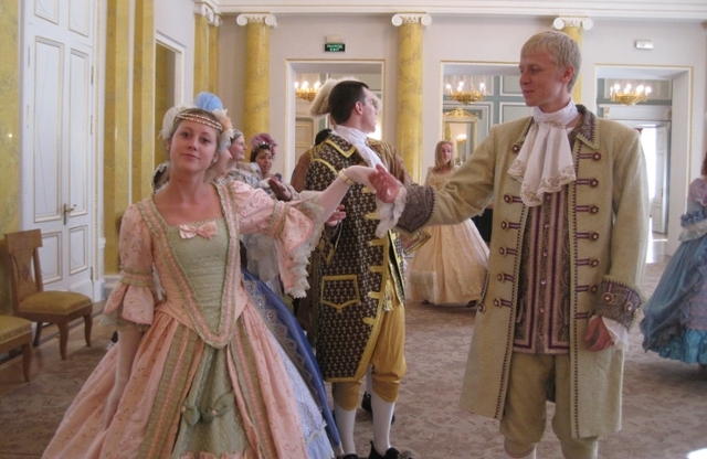 Students dancing in ballroom wearing period costuming