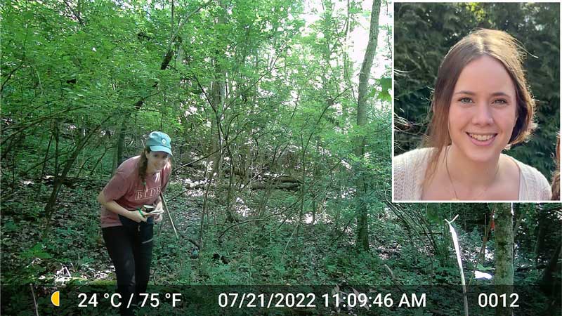 Elea Cooper '24 in a local forest near one of the trail cameras she set up for her research. 