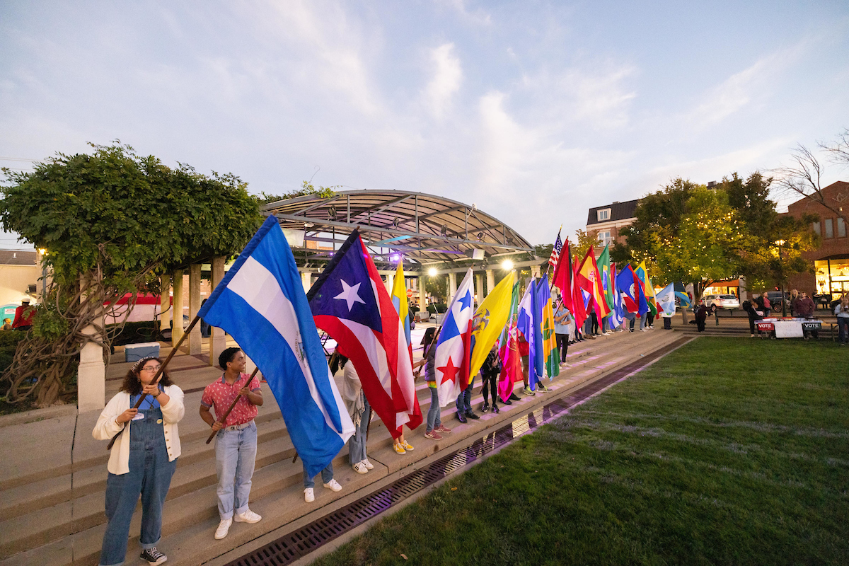 Students and community individuals hold the flags of Latin American and Caribbean countries at the 2022 Latin American and Caribbean UniDiversity Festival.