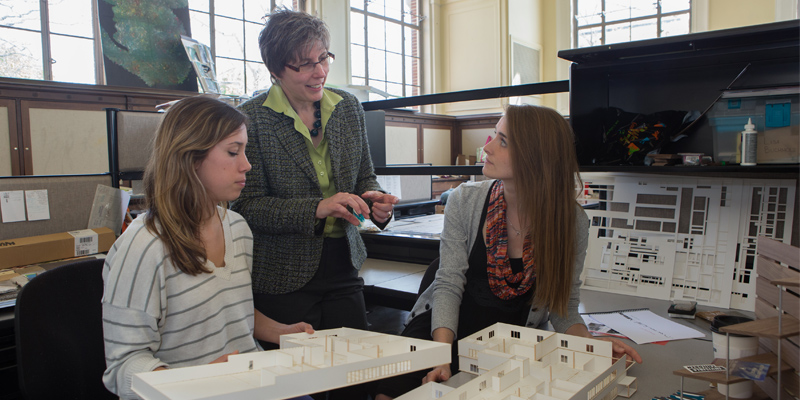Katherine Setser with two students