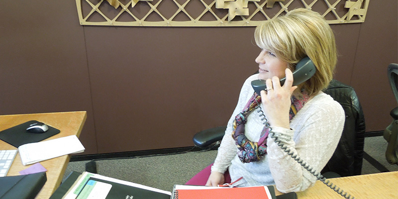 Lori Gouvan talks on a telephone at her desk