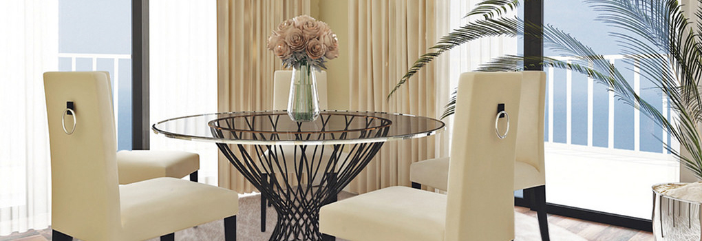 A table and chairs near a window in a tastefully decorated apartment