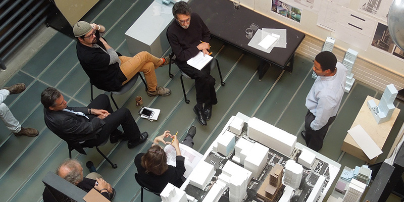 overhead view of faculty at a student review