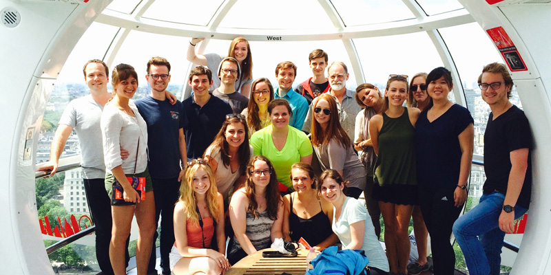 Smiling students pose within the London Eye