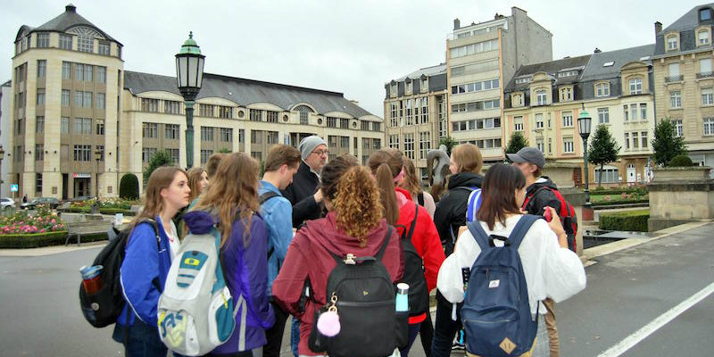 A group of students face away from the camera as they participate in a tour in 2017
