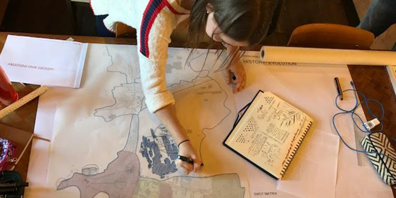 An overhead view of Caroline Berlage at drawing table