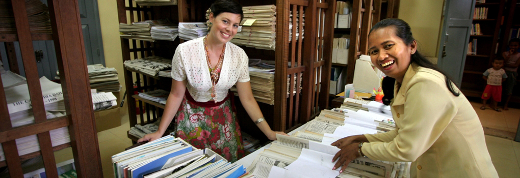 Two women catalogue materials at a museum