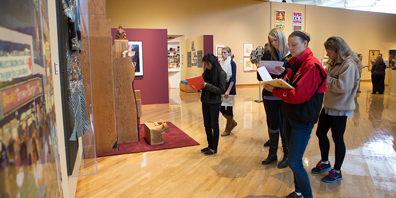Students at the Miami Art Museum take notes as they view artworks