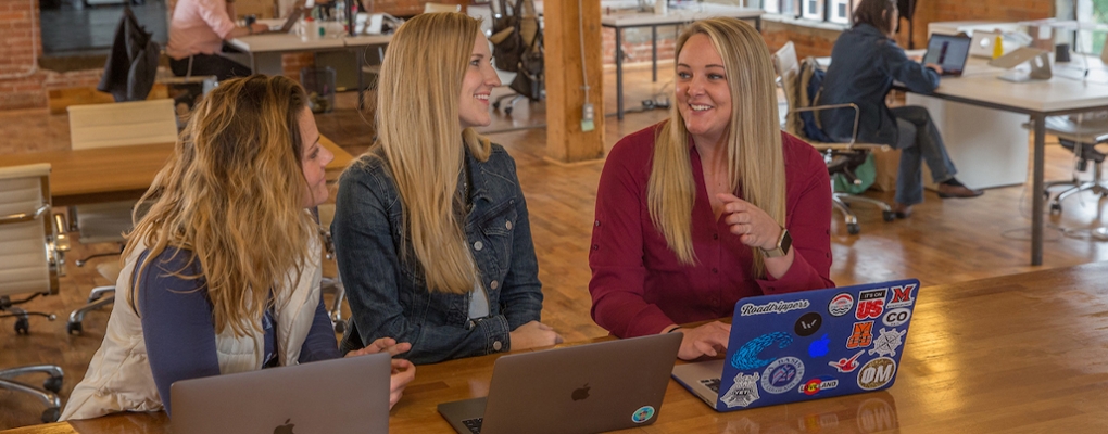 three students working on laptops at Roadtrippers