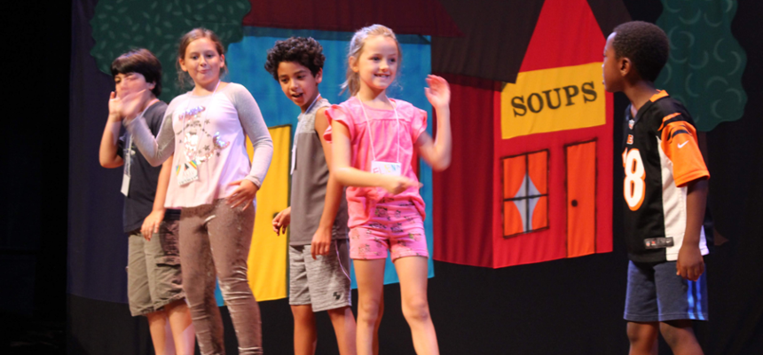 Group of children rehearsing a play onstage