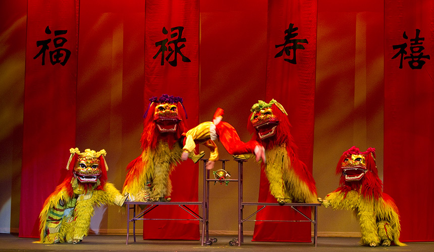 Performers in traditional chinese dragon costumes in bright red and gold