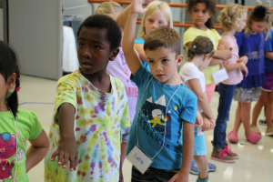 Two young boys with their hands stretched outwards