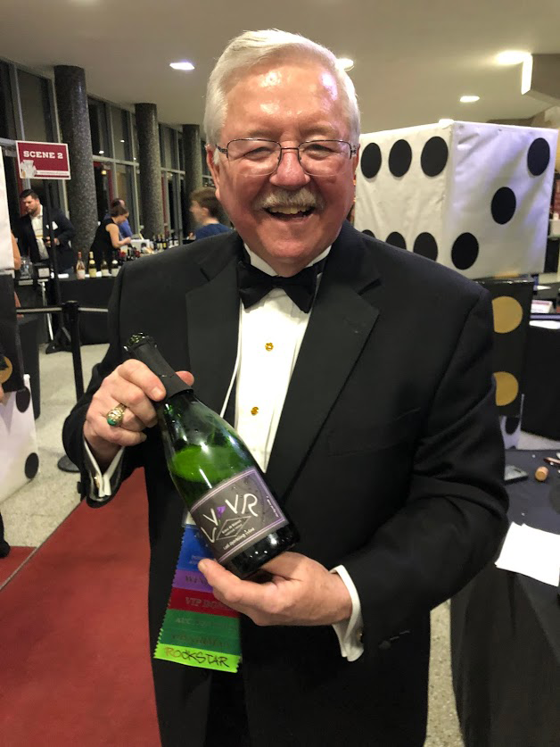 Jack Keegan holds a bottle toward the camera