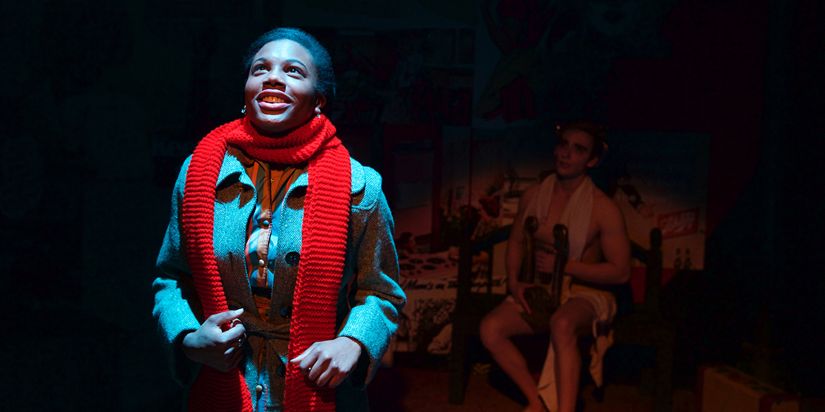 A woman dressed in a coat and scarf looks upward in a scene from Bliss, or Emily Post Is Dead