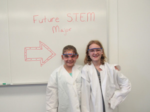 Girls in lab coats on Girl Scout Day 2018