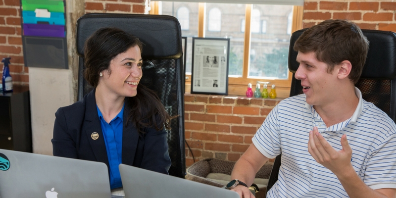 two students sitting and talking
