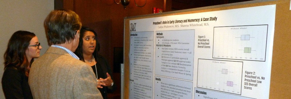 student presenting her research poster