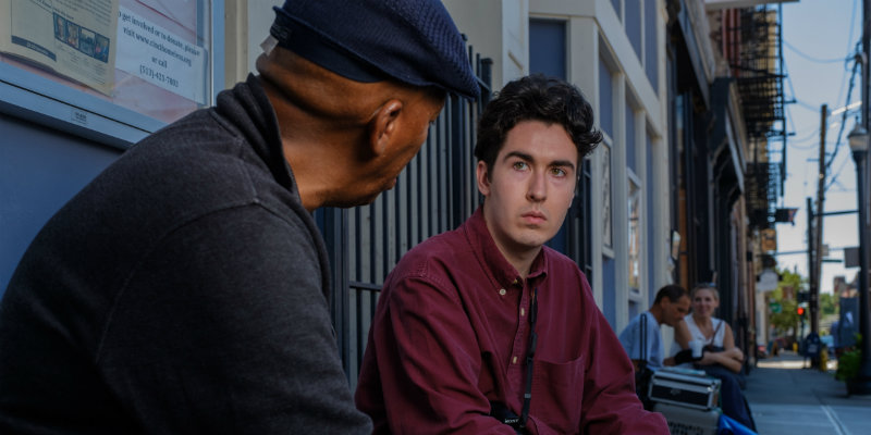 An african-american male, and a white male have a deep conversation