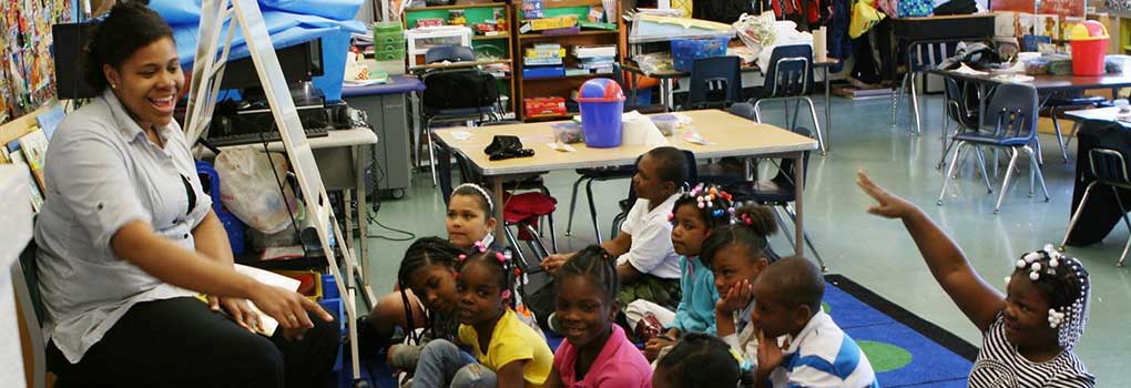 a student in the Urban Cohort program talking to young students