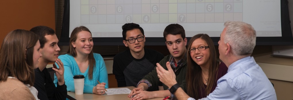 students sitting around a table having a discussion