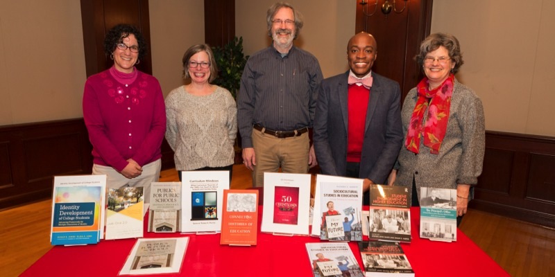 ehs faculty stand over books they wrote