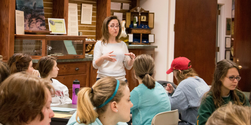 professor teaching students in a small room
