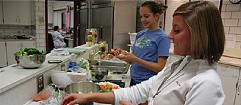 two students cooking in a dietetics lab