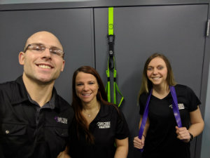 Adam Ortman takes picture with other Anytime Fitness employees