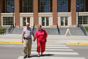Alumni couple crossing street