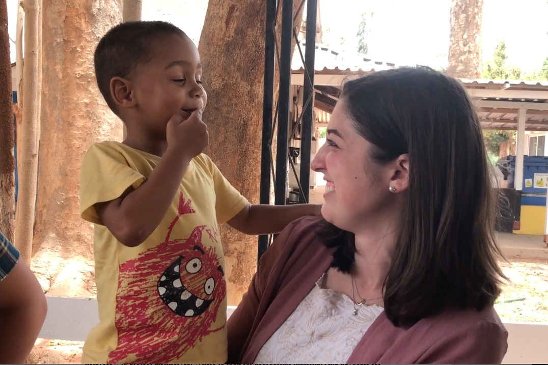 emily krile takes picture with a child in the Gambia