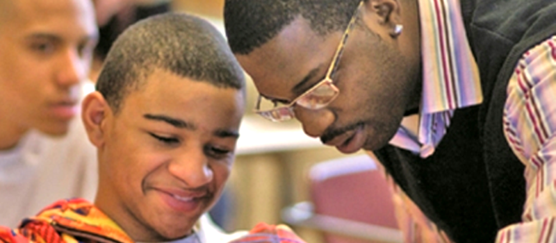 teacher helping student with work