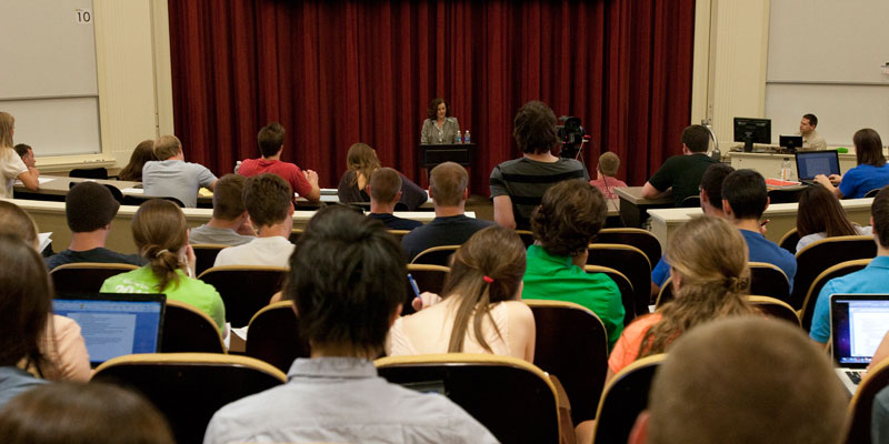 Speaker talking with students in auditorium