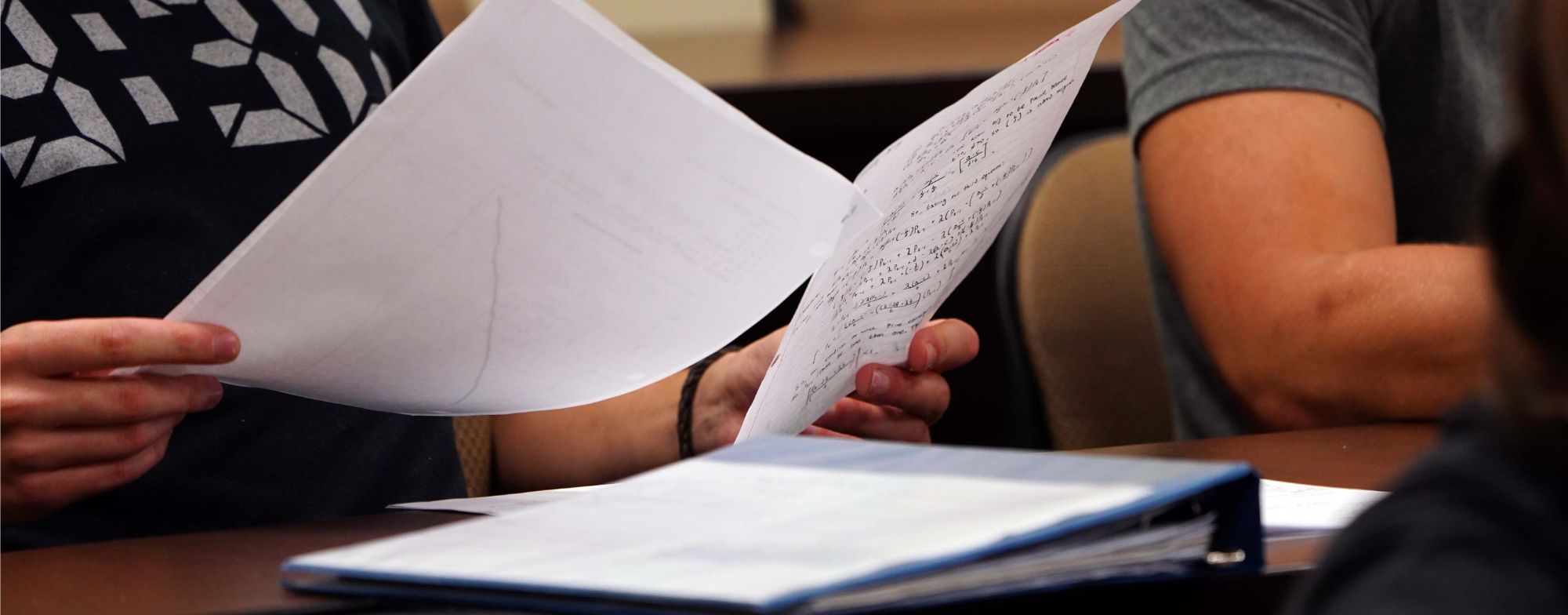 Hands holding homework