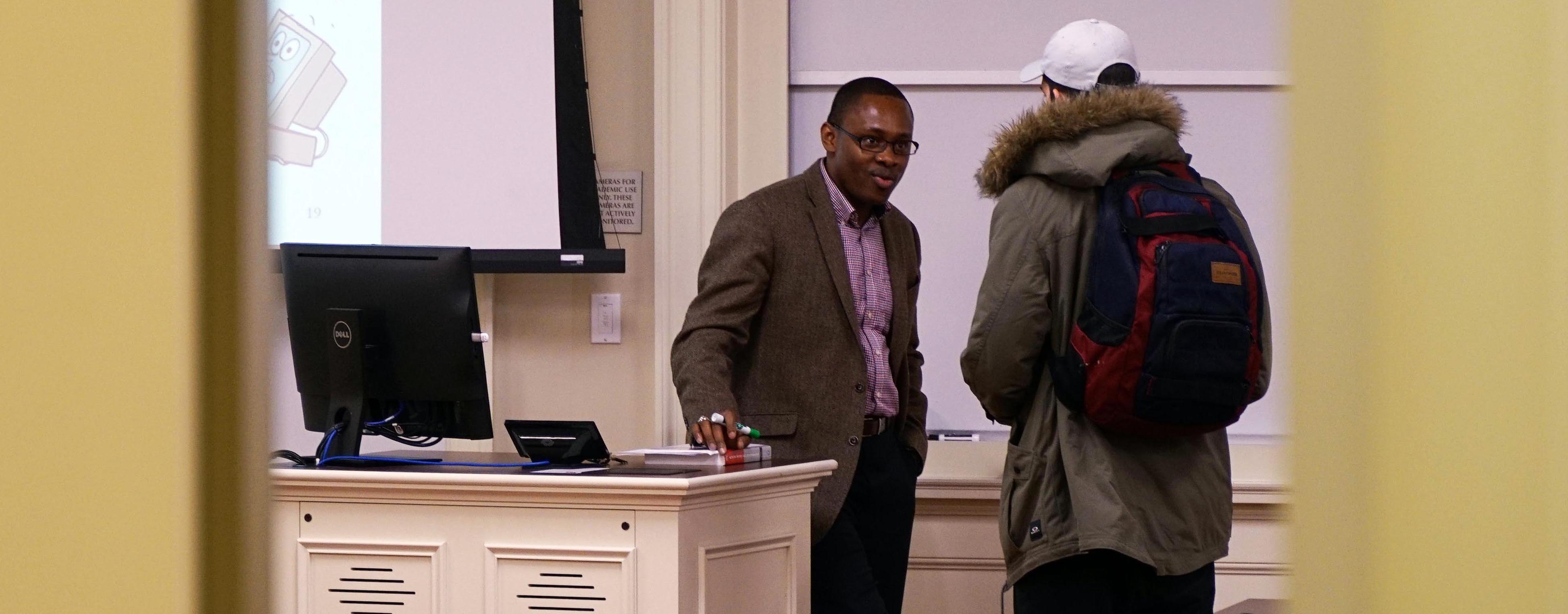 Joseph Nwankpa talks with a student before class