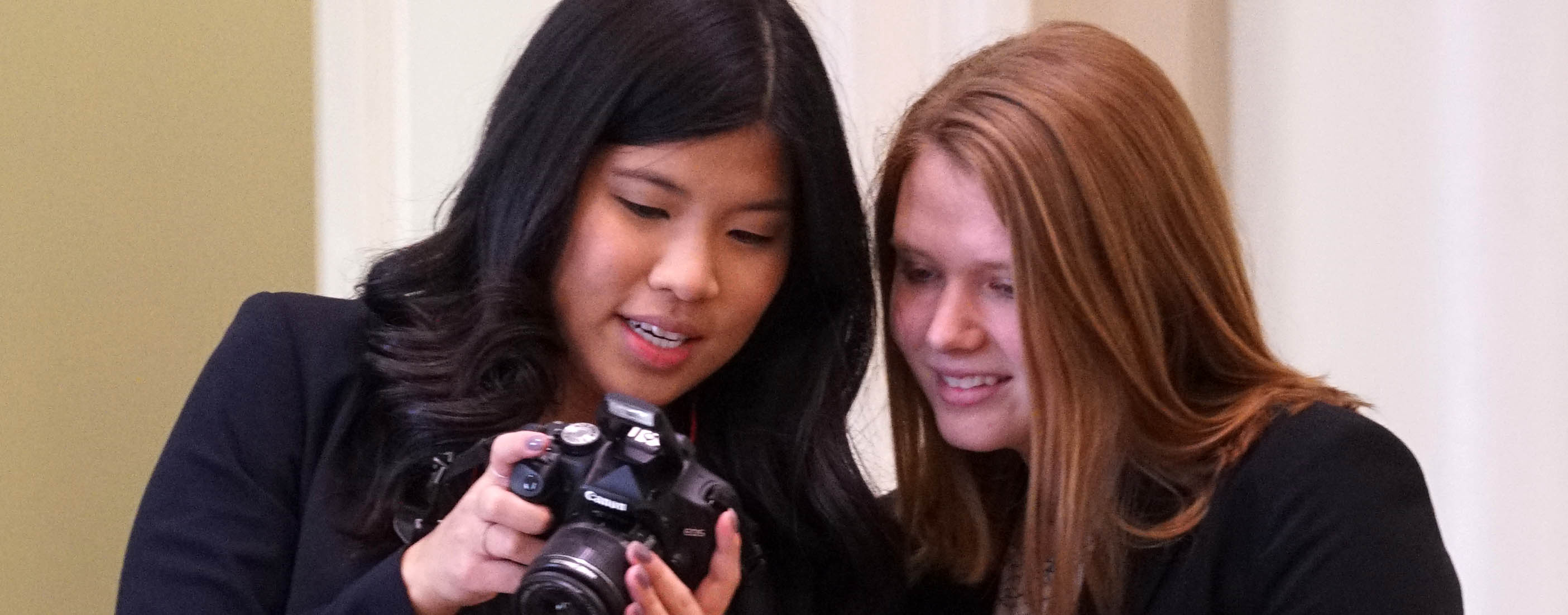 Women look over image on back of camera
