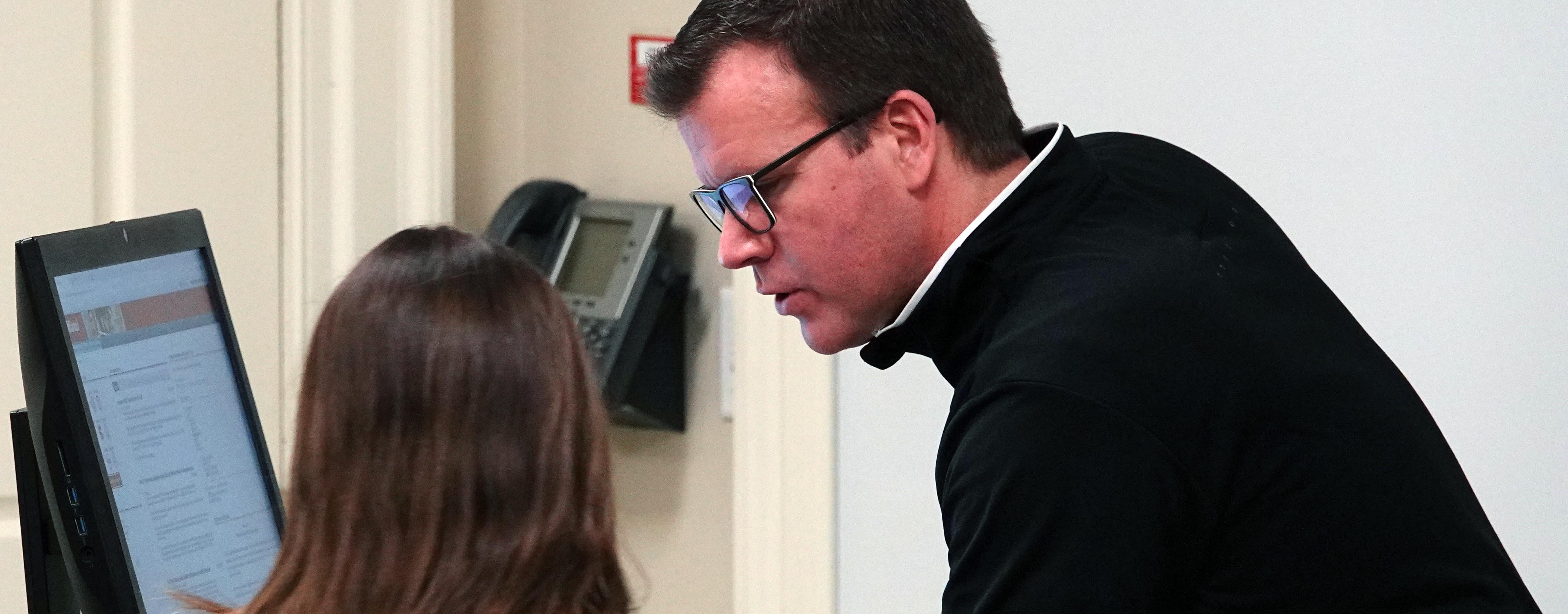 Professor talking with student at computer