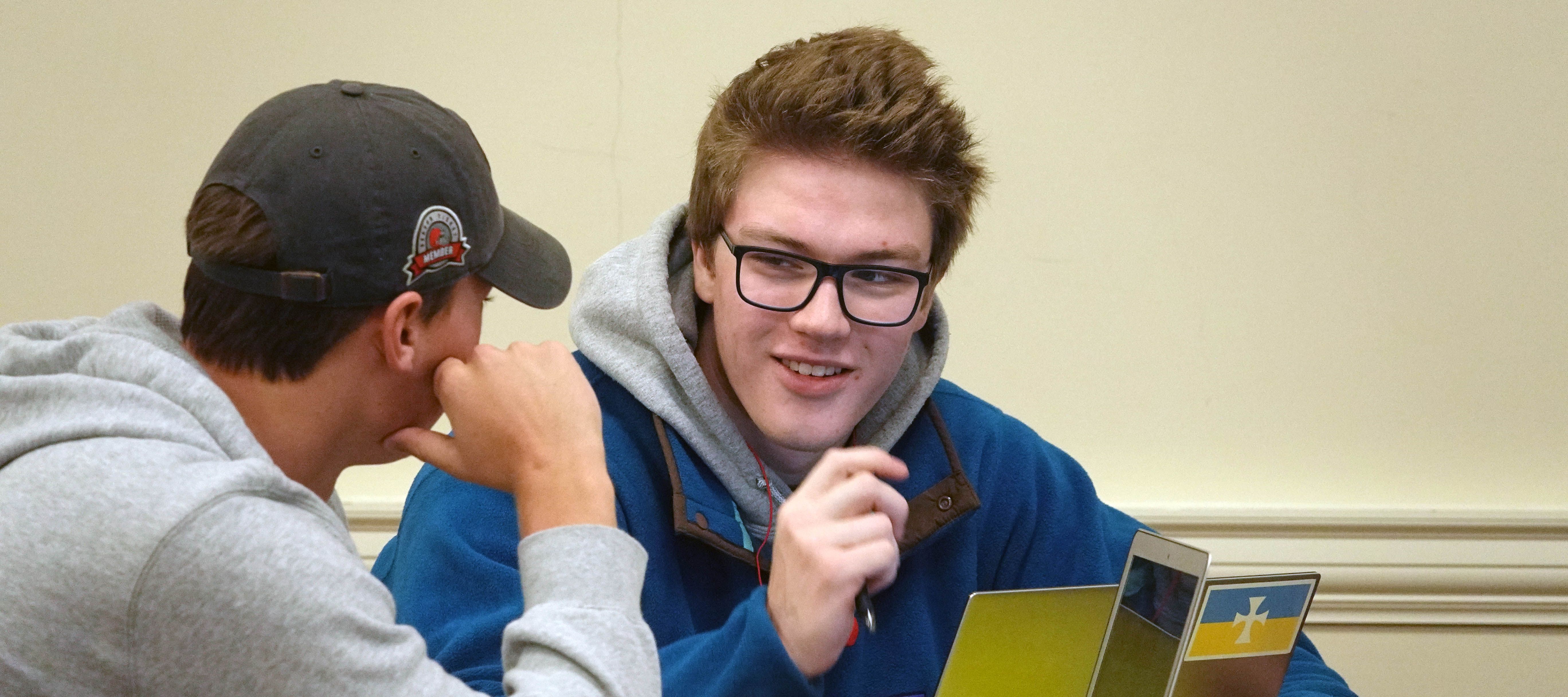 A student talks with another in Don Norris' marketing class